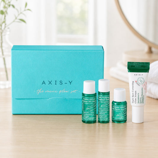 AXIS-Y Mini Glow Set with teal box, essence oil, toner, ampoule, and dark spot serum skincare travel kit.